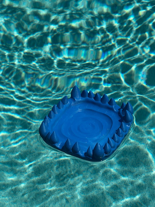Blue 3D printed Flesh and Flowers tray photographed in water