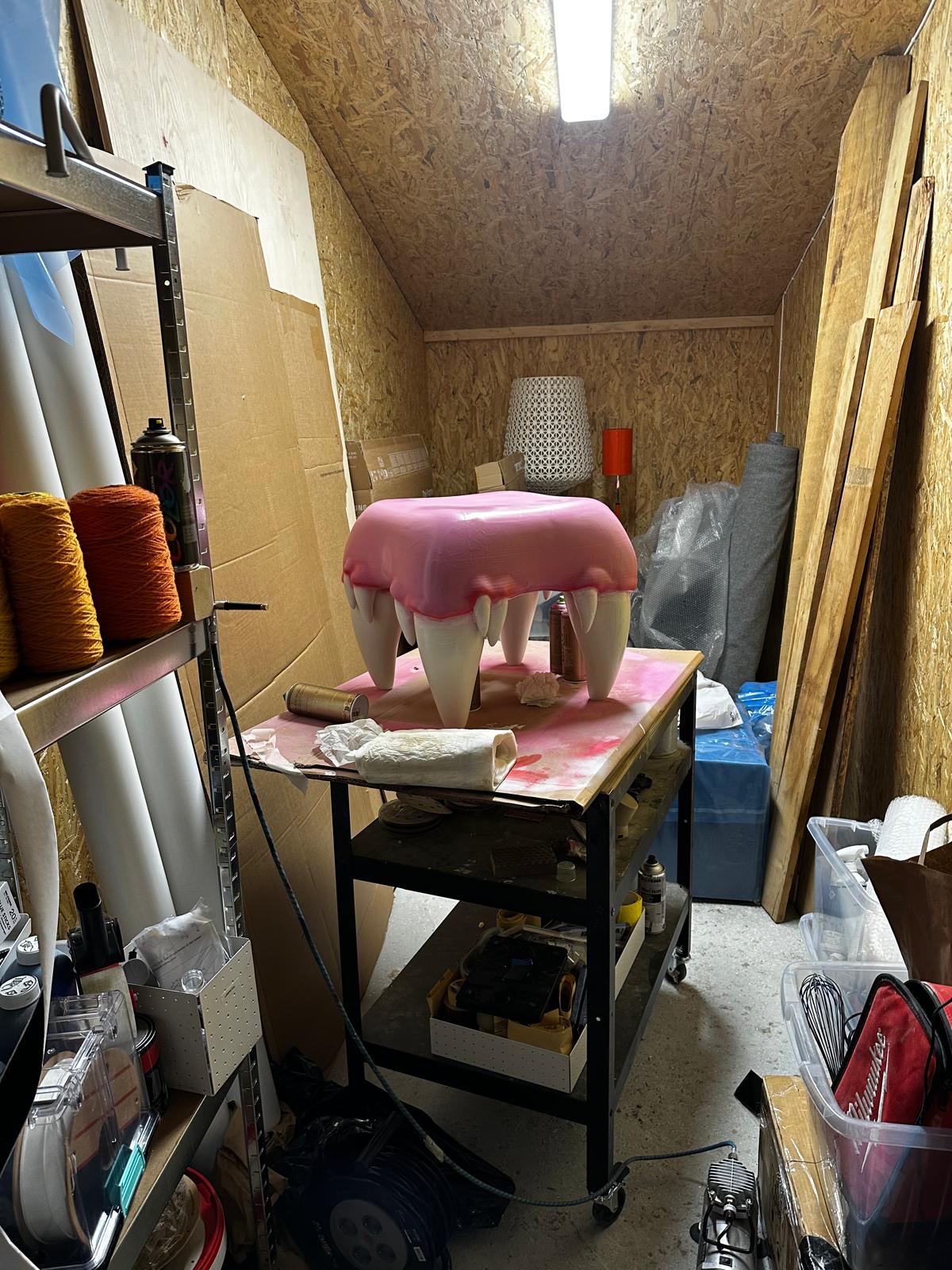 Pink tooth-like studio prototype on a work table
